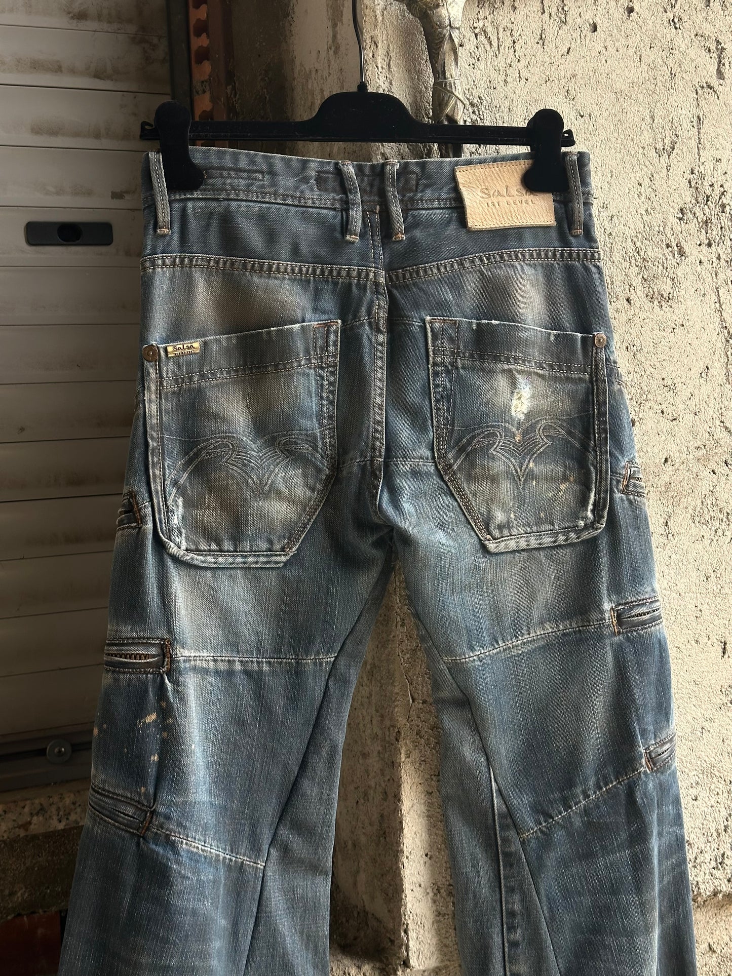 MULTI ZIPPED FLARED DENIM PANTS