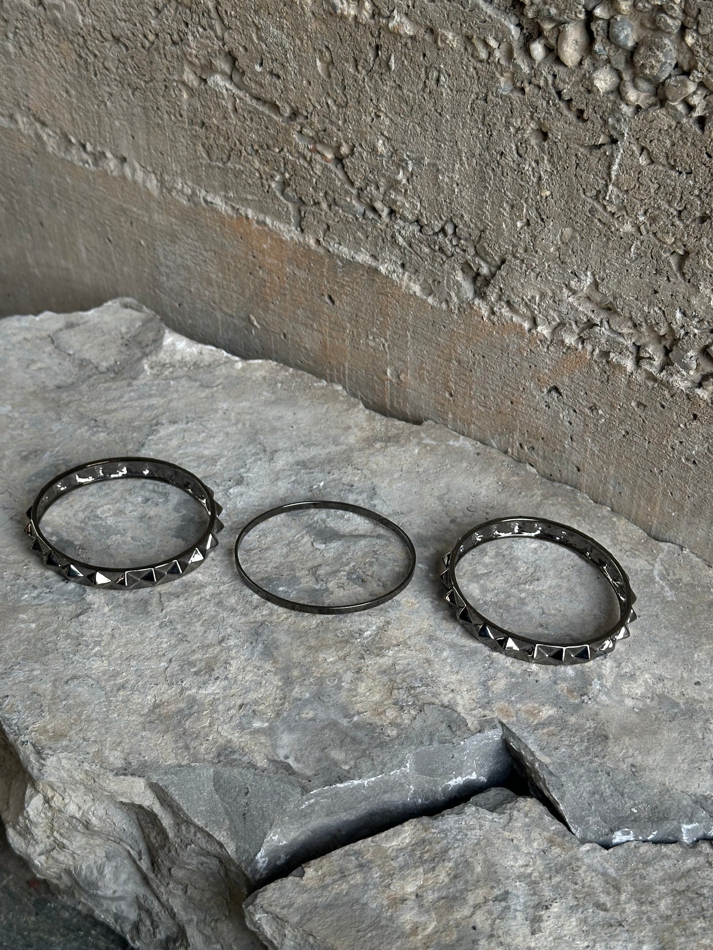 THREE STUDDED SILVER BRACELETS