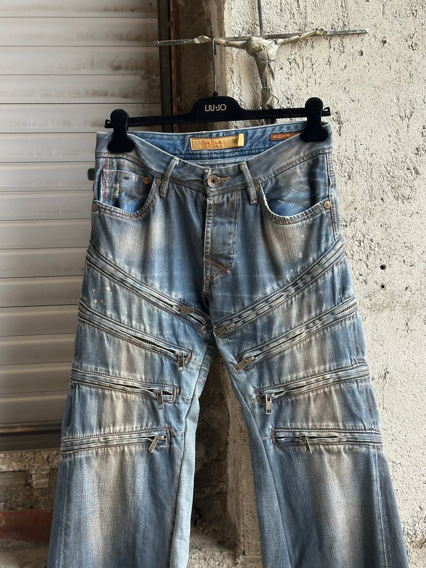 MULTI ZIPPED FLARED DENIM PANTS