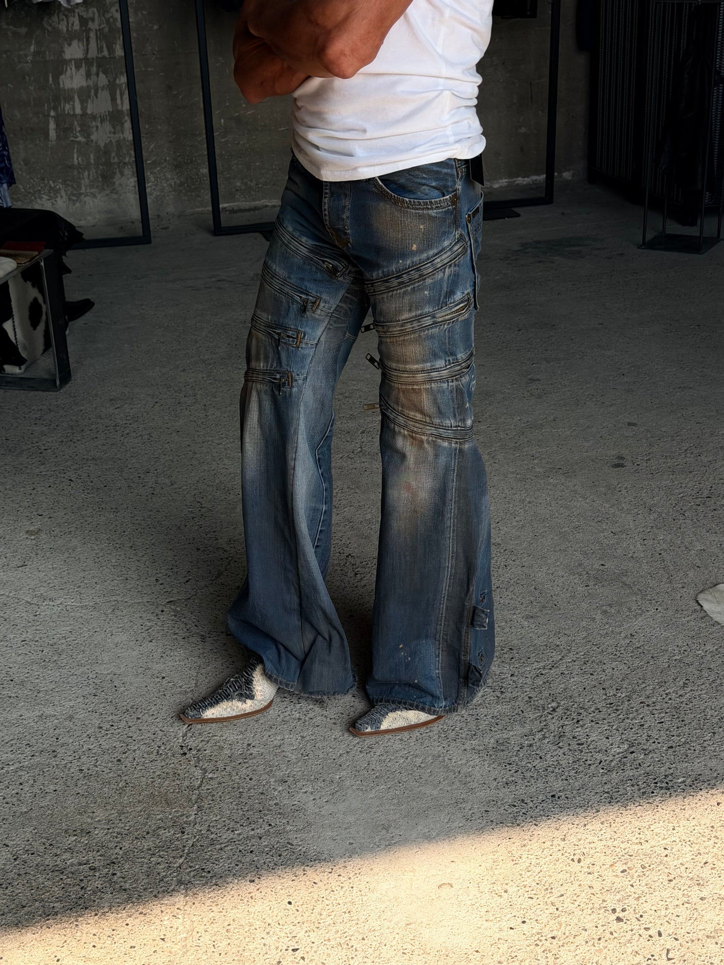 MULTI ZIPPED FLARED DENIM PANTS