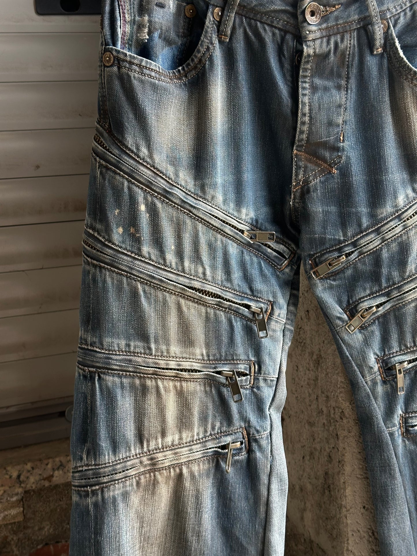 MULTI ZIPPED FLARED DENIM PANTS