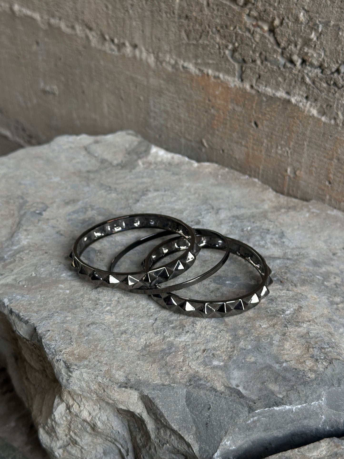 THREE STUDDED SILVER BRACELETS